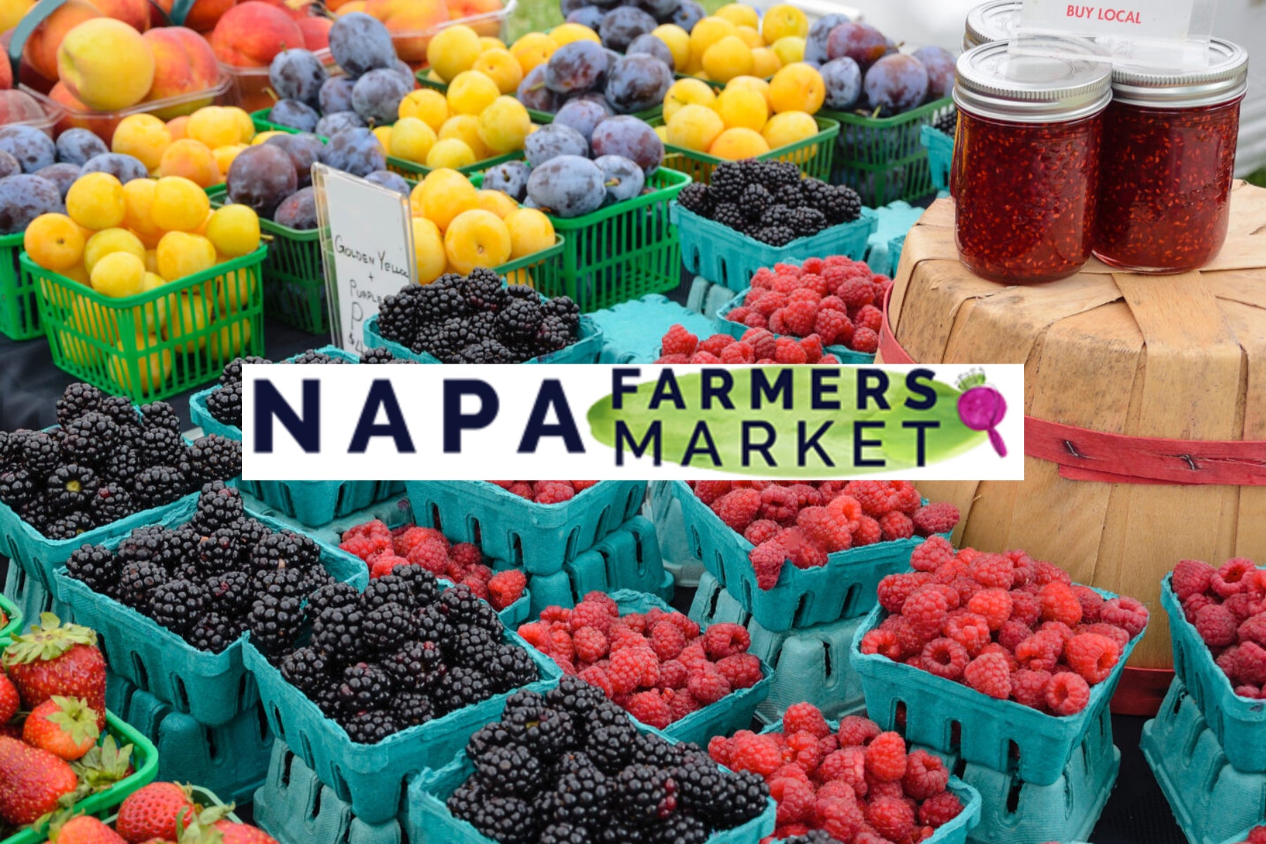 Napa Farmers Market with fresh fruits and berries displayed in baskets.
