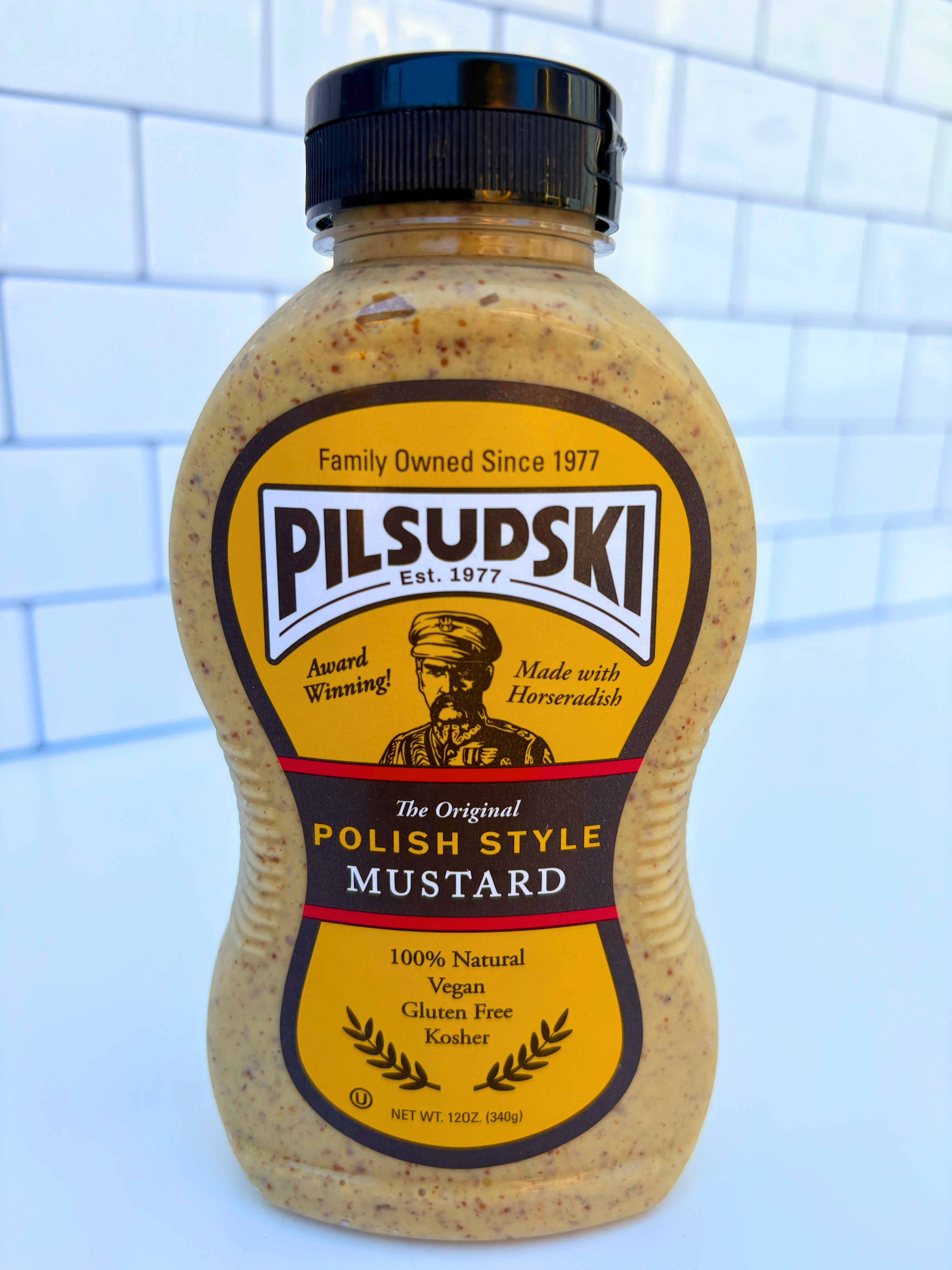 Pilsudski Polish Style Mustard bottle on a tiled wall background